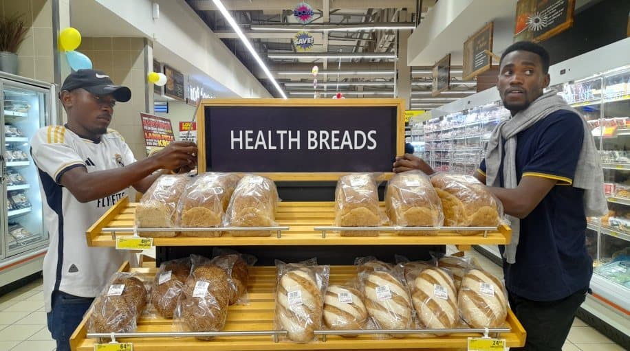 In-store bakery shelf signage installed above a bread display
