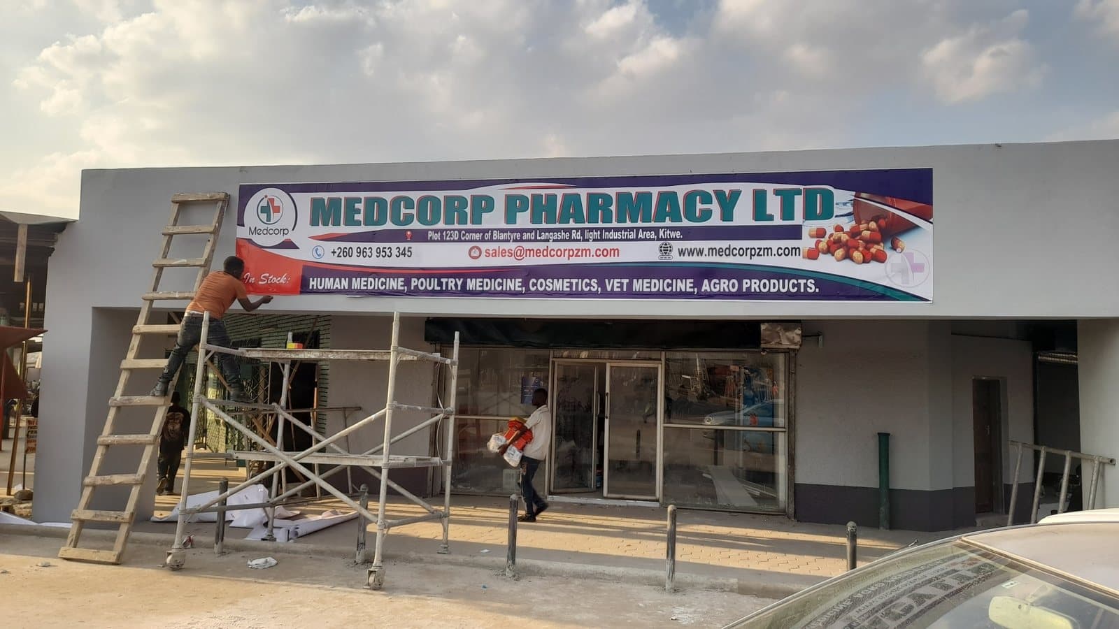 Shopfront fascia banner being installed at Medcorp Pharmacy