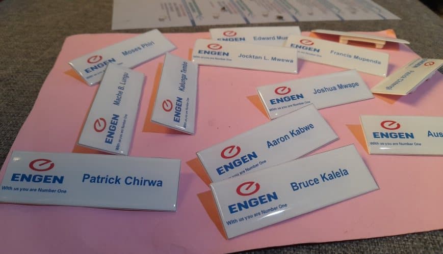 Branded Engen staff name tags laid out after production