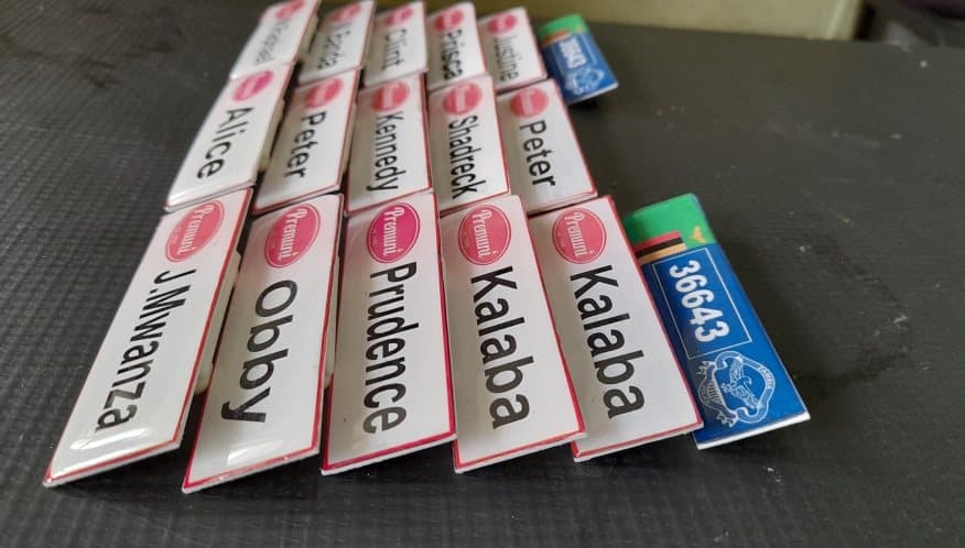 Printed staff name badges laid out after finishing