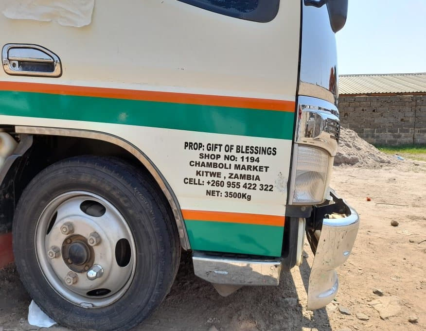 Delivery truck branded with vinyl graphics and trading details